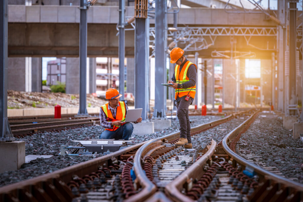 Engineer under inspection and checking construction process rail